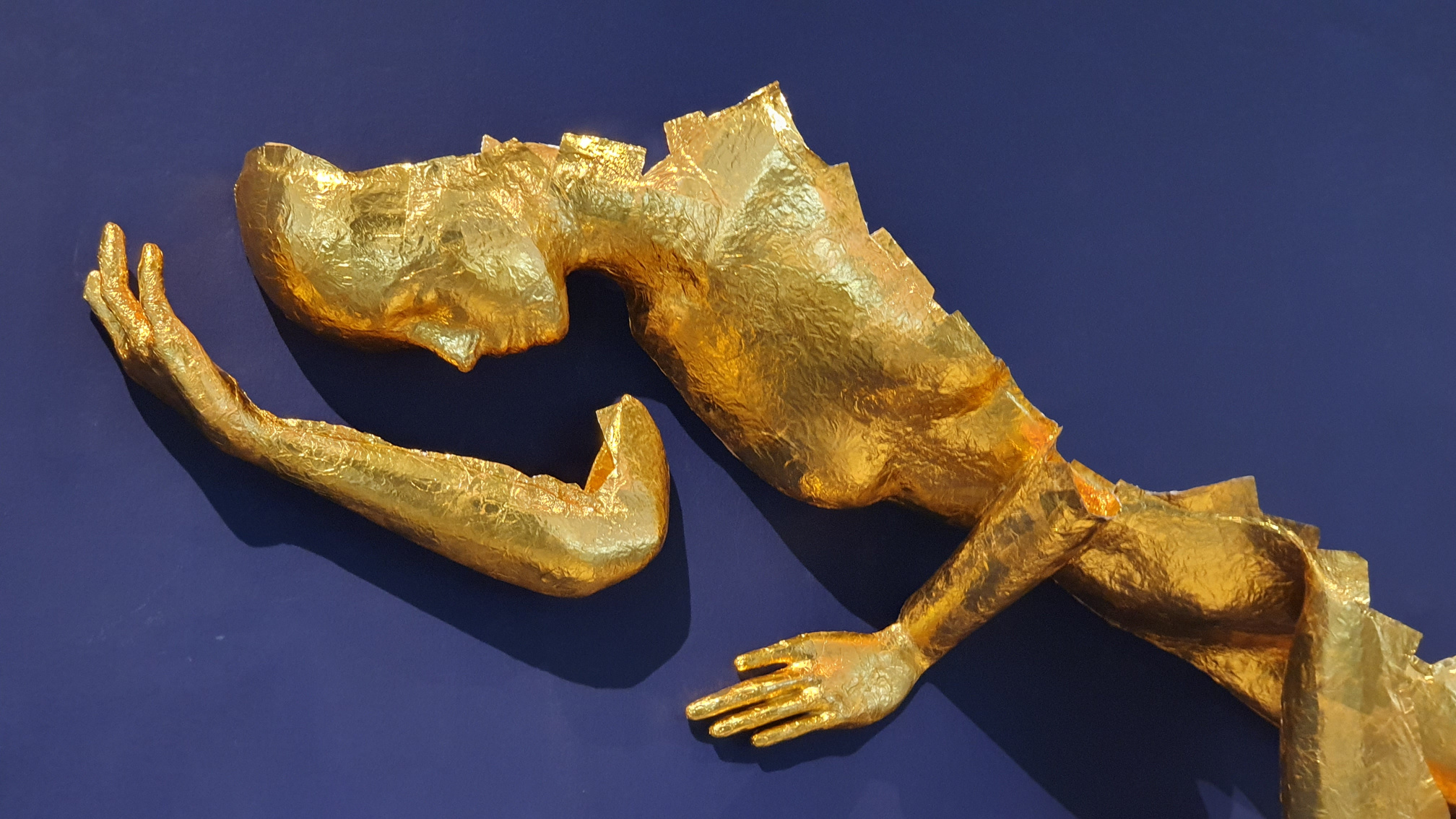 Golden foil paper covering 3D printed human sculpture